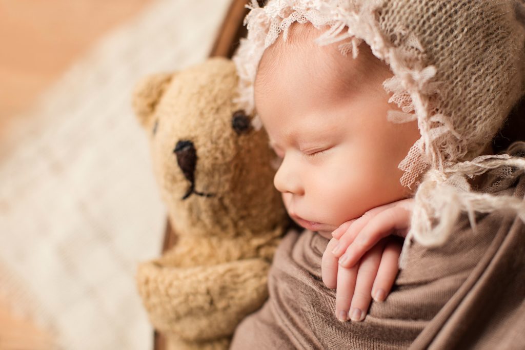 newborn with teddy bear