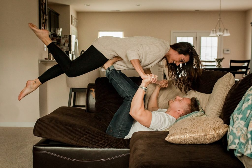 lifestyle couple on couch lifted in air