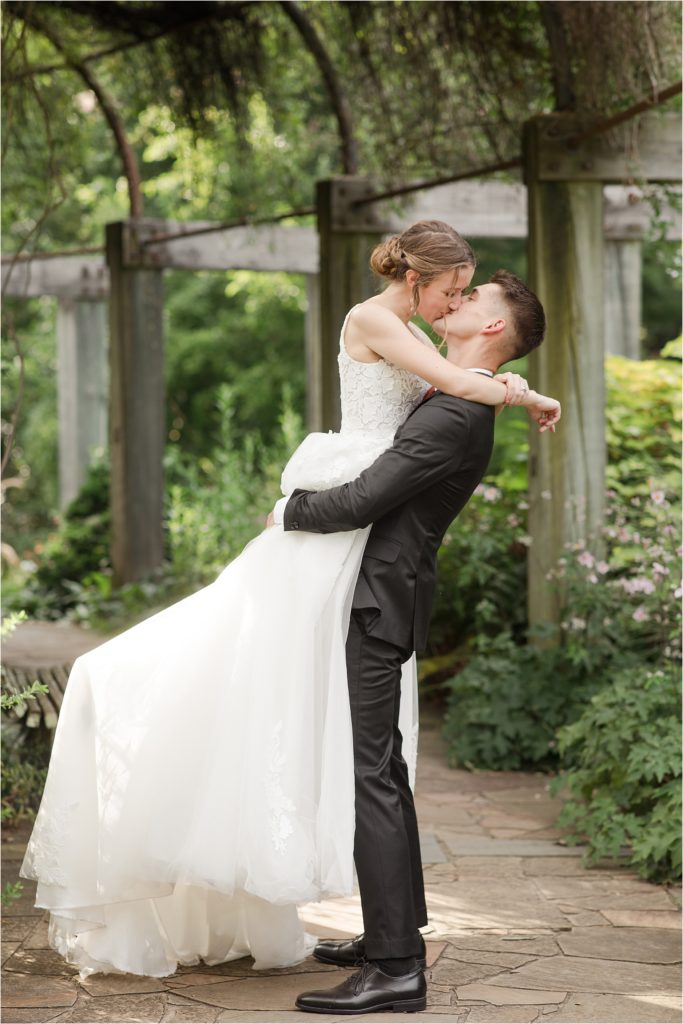 groom lifting bride and kissing